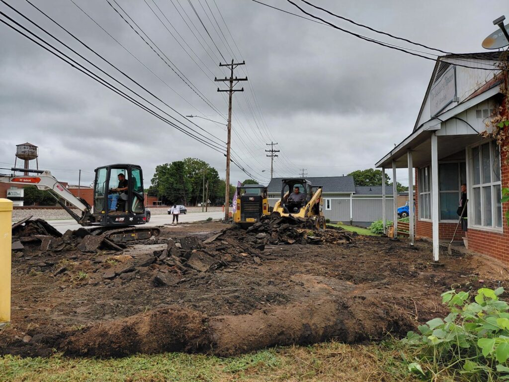 Bobcat mini excavator and CAT skid steer tearing out an old parking lot in Stanley, NC